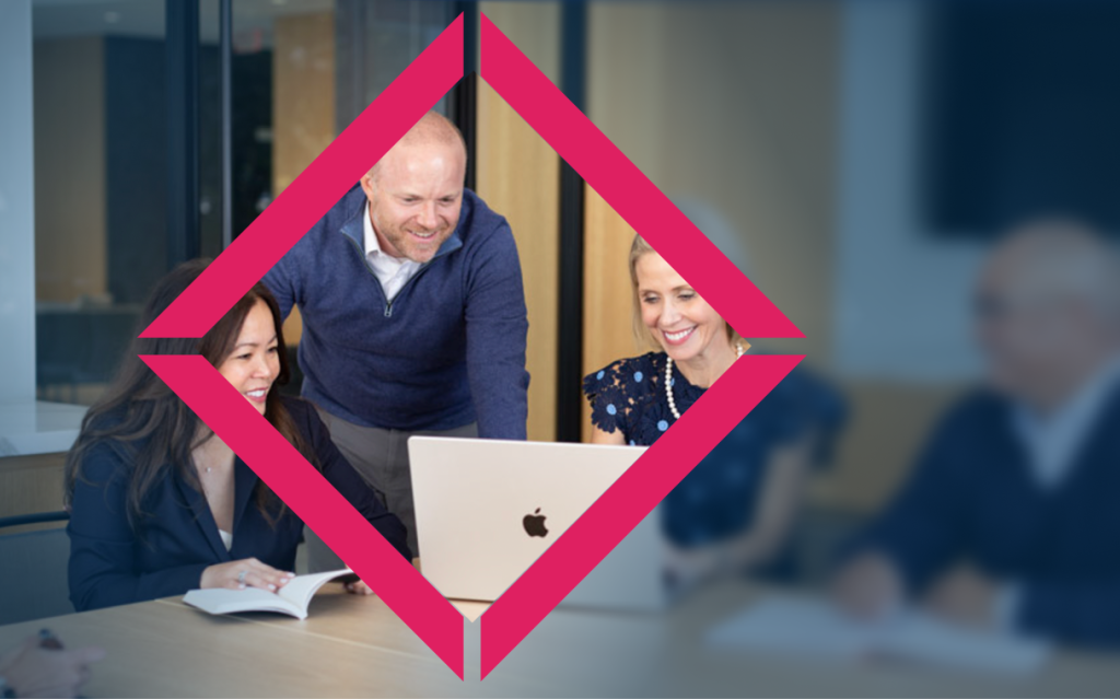 Team looking at computer in meeting